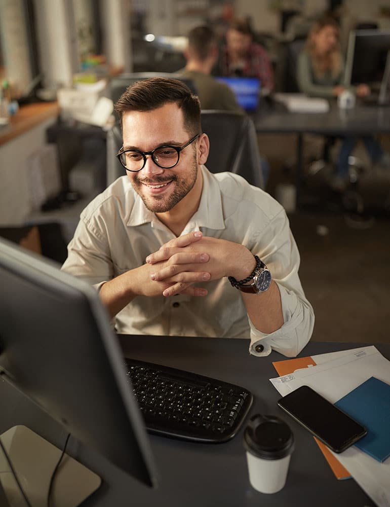 Cybersecurity professional working at a laptop